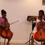 Cello duet at the O'Connor Method Camp NYC between Teacher Trainer Taiwo from Nigeria and camp student. Photo by Richard Casamento.