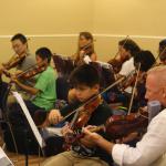 Teachers and students sit side by side in the All Camp Orchestra at the O'Connor Method Camp NYC. Photo by Richard Casamento. 